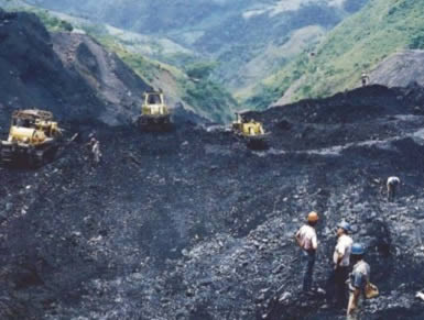 Bulldozers are clearing away the black shale