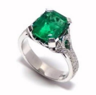 An emerald and diamond ring